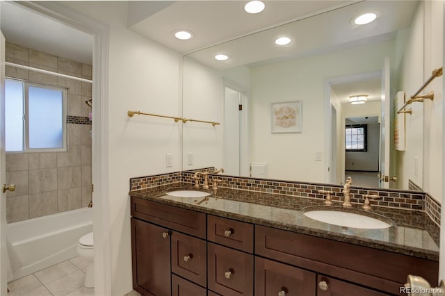 full bath with toilet, a healthy amount of sunlight, decorative backsplash, and a sink