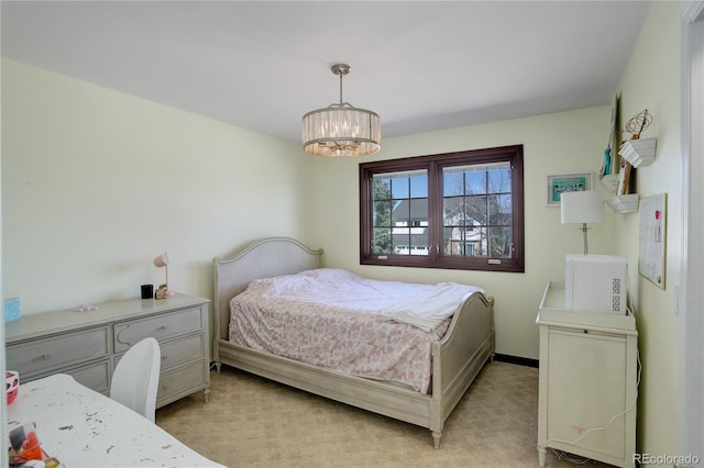 bedroom with baseboards, an inviting chandelier, and light colored carpet