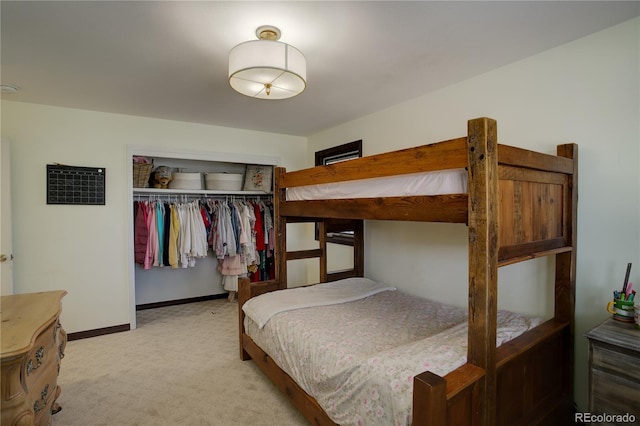 bedroom with carpet, baseboards, and a closet