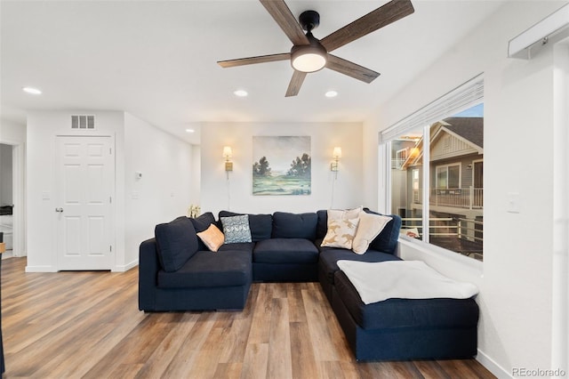 living area with visible vents, recessed lighting, baseboards, and wood finished floors