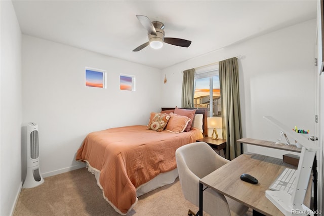 bedroom featuring ceiling fan, baseboards, and light carpet