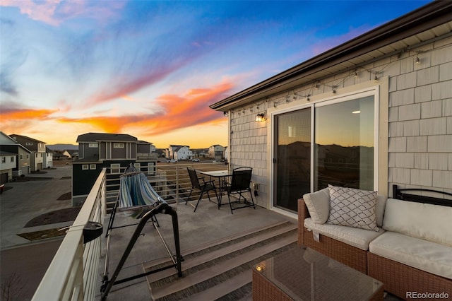 deck at dusk with an outdoor hangout area