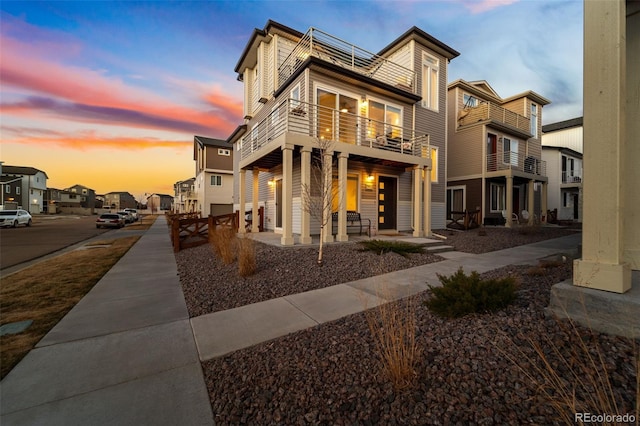 rear view of house with a residential view and a balcony