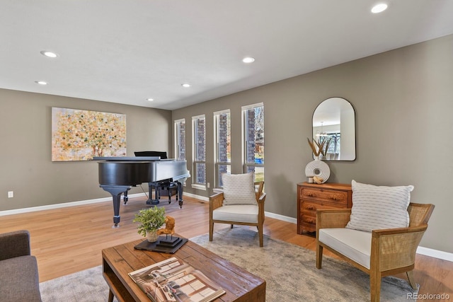 living area with recessed lighting, baseboards, and wood finished floors