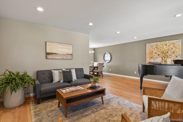 living area with recessed lighting, baseboards, and wood finished floors