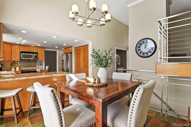 dining space with recessed lighting, a chandelier, and stone tile flooring