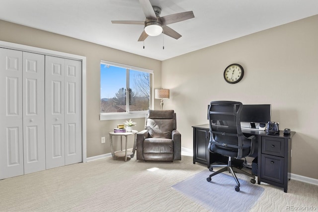 home office with ceiling fan, baseboards, and light carpet