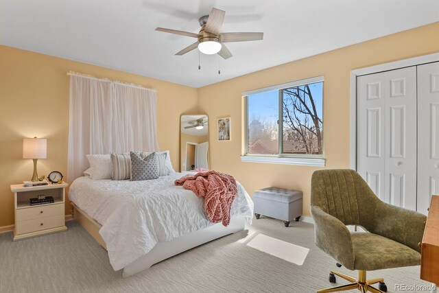 carpeted bedroom featuring a closet, a ceiling fan, and baseboards