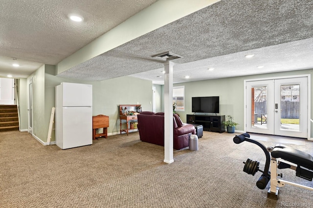 interior space featuring visible vents, a textured ceiling, recessed lighting, carpet flooring, and baseboards