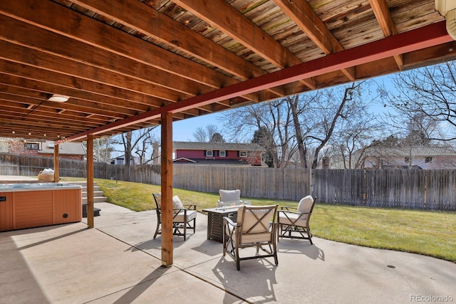 view of patio featuring a fire pit, a fenced backyard, and a hot tub