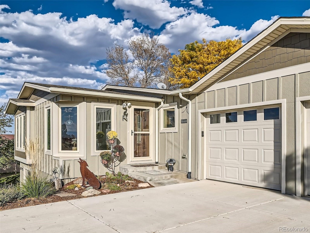 view of front of home with board and batten siding, driveway, and a garage