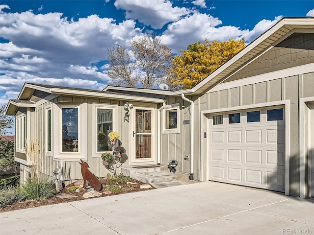 view of front of home with board and batten siding, driveway, and a garage