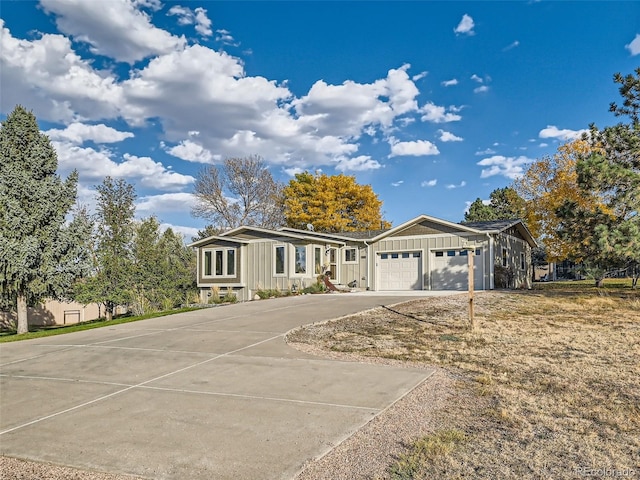 view of front facade featuring board and batten siding, concrete driveway, and an attached garage