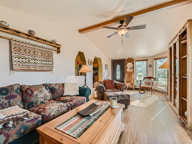 living room featuring lofted ceiling with beams, wood finished floors, and a ceiling fan