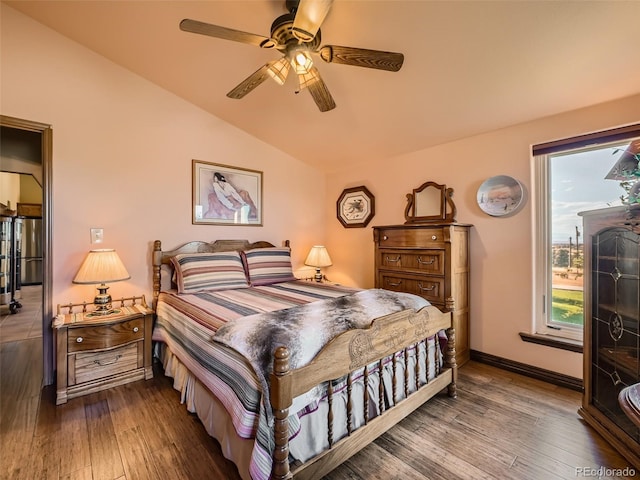 bedroom with lofted ceiling, ceiling fan, baseboards, and wood finished floors