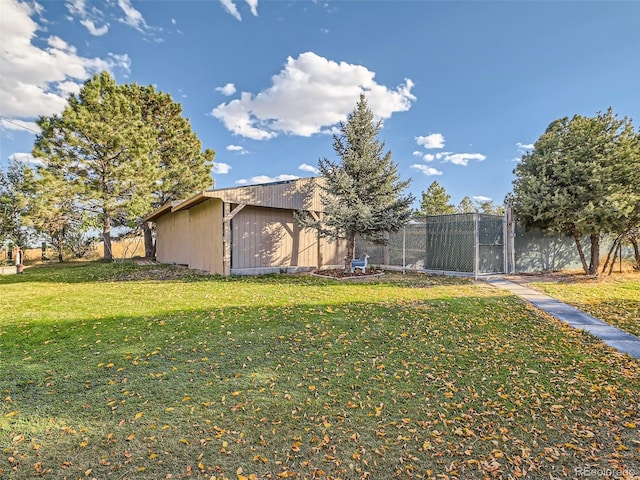 exterior space featuring an outbuilding, fence, and a gate