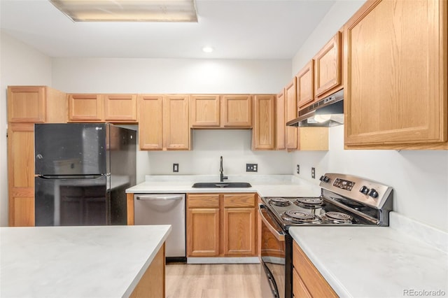 12931 Lafayette St Unit G, Thornton, CO 80241 - kitchen featuring appliances with stainless steel finishes, under cabinet range hood, light countertops, light wood finished floors, and recessed lighting