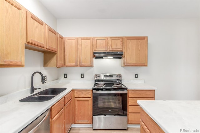 12931 Lafayette St Unit G, Thornton, CO 80241 - kitchen with appliances with stainless steel finishes, under cabinet range hood, light countertops, and light brown cabinets