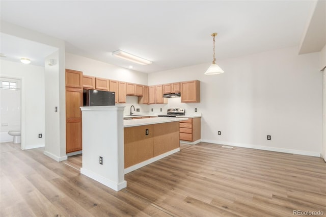 12931 Lafayette St Unit G, Thornton, CO 80241 - kitchen featuring fridge, light wood finished floors, light countertops, electric stove, and a center island