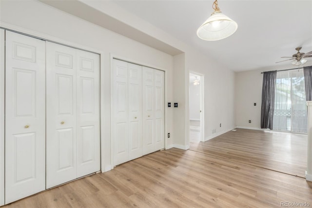 12931 Lafayette St Unit G, Thornton, CO 80241 - unfurnished bedroom featuring multiple closets and light wood-type flooring