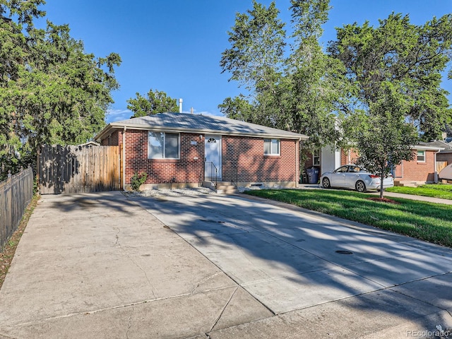 1731 Uinta St, Denver, CO 80220 - view of front facade featuring entry steps, driveway, and brick siding