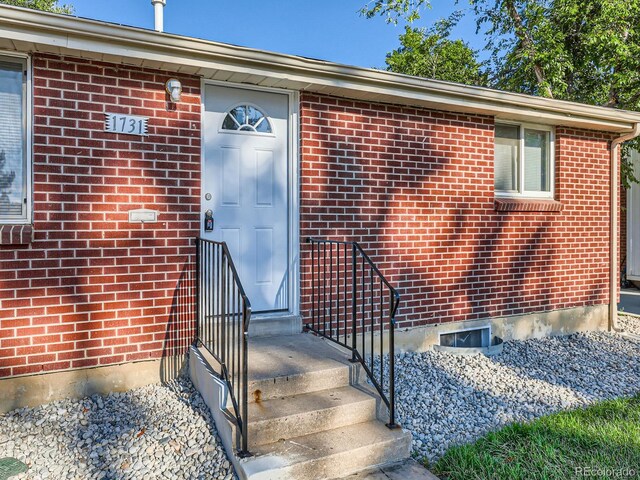 1731 Uinta St, Denver, CO 80220 - doorway to property with brick siding