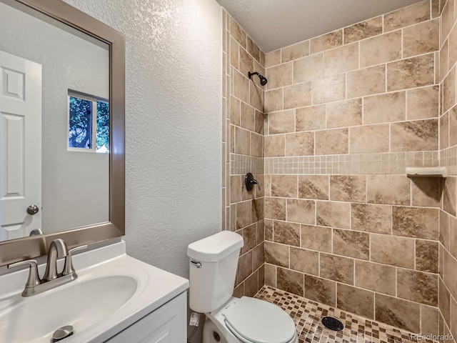 1731 Uinta St, Denver, CO 80220 - full bathroom featuring a textured wall, a tile shower, and vanity