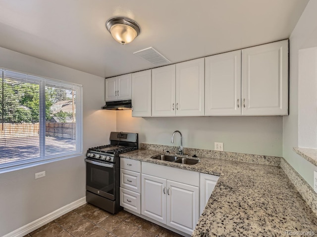 1731 Uinta St, Denver, CO 80220 - kitchen with stainless steel gas range, range hood, white cabinetry, and light stone counters
