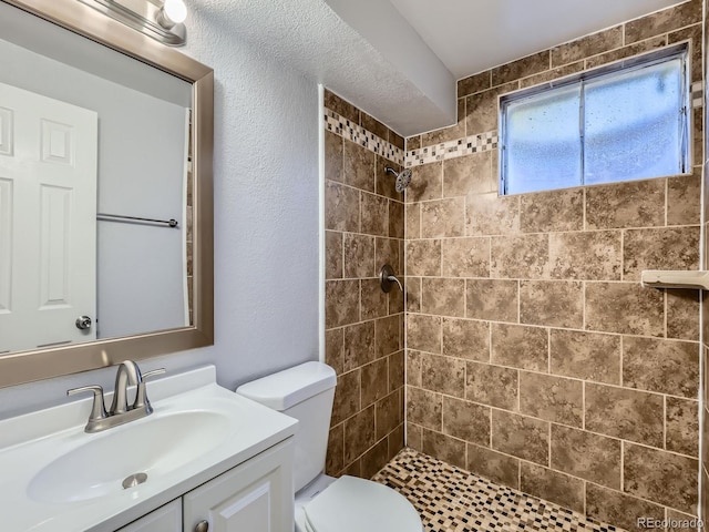 1731 Uinta St, Denver, CO 80220 - bathroom with a tile shower, vanity, and a textured wall