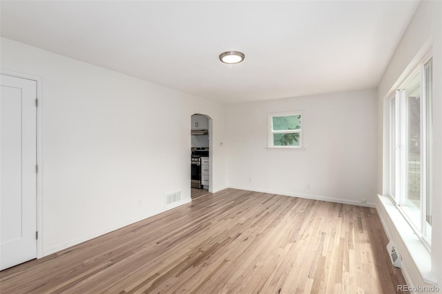 1780 Alton St, Aurora, CO 80010 - unfurnished room with arched walkways and light wood finished floors