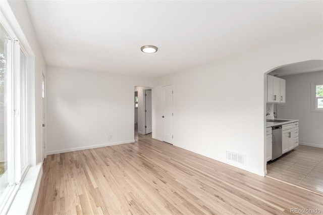 1780 Alton St, Aurora, CO 80010 - empty room with arched walkways and light wood finished floors