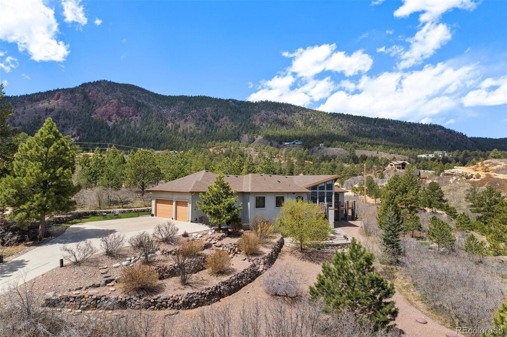 view of front of property with a garage and a mountain view