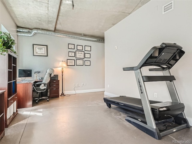 exercise room featuring concrete floors