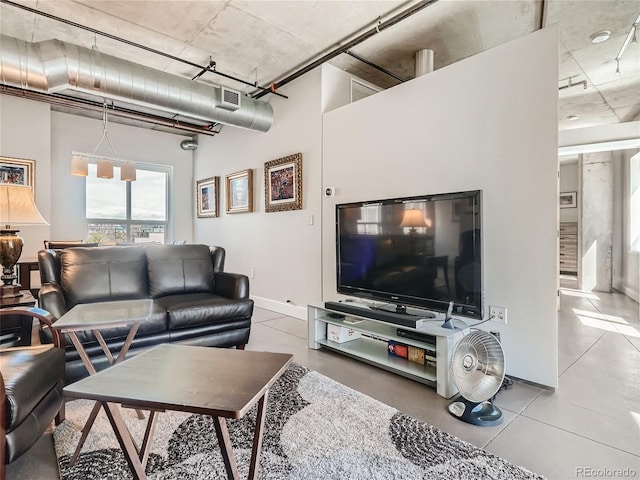 tiled living room with a towering ceiling