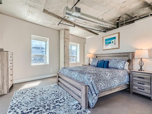 bedroom featuring concrete flooring