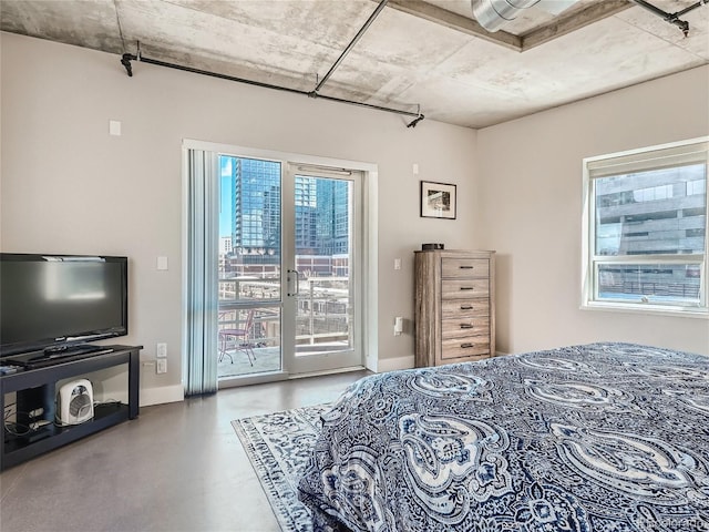 bedroom with french doors, concrete floors, and access to exterior