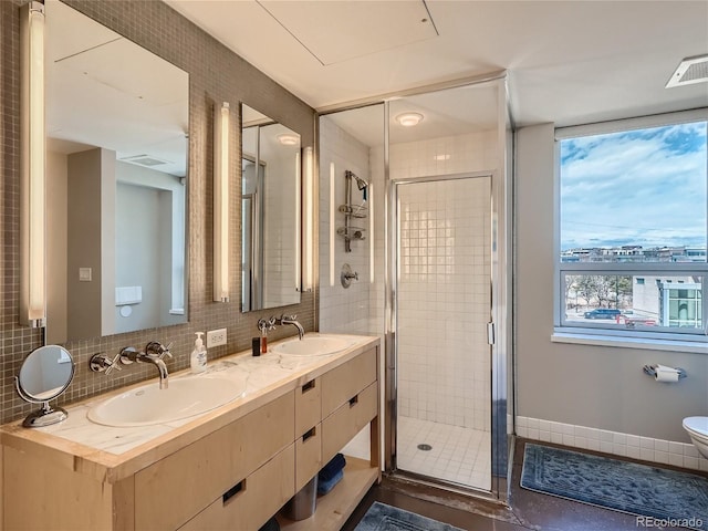 bathroom with backsplash, an enclosed shower, toilet, and dual vanity