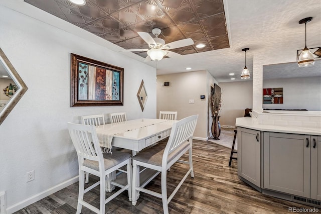 dining area with dark hardwood / wood-style floors and ceiling fan