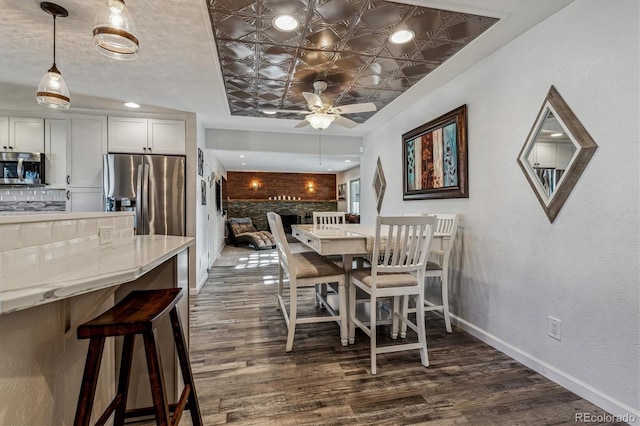 dining room featuring ceiling fan and dark hardwood / wood-style flooring