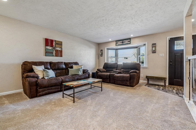 carpeted living room featuring a textured ceiling