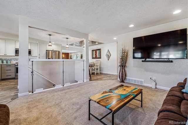 carpeted living room with a textured ceiling