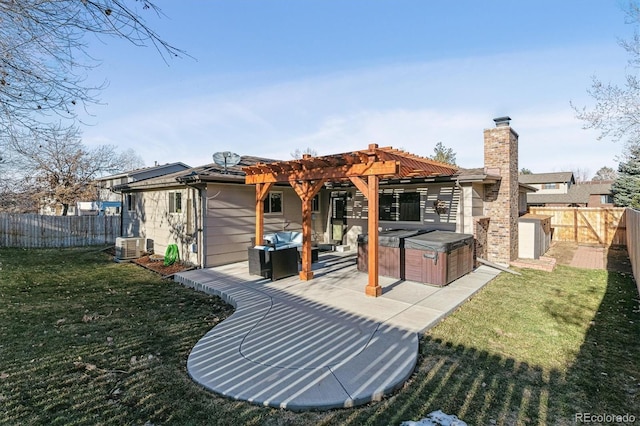 rear view of property with a lawn, central AC unit, a pergola, a hot tub, and a patio area