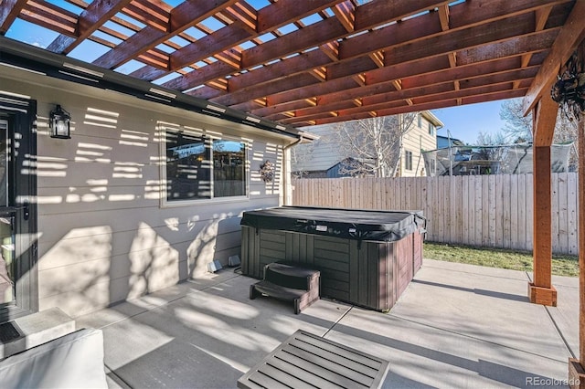 view of patio with a hot tub and a pergola