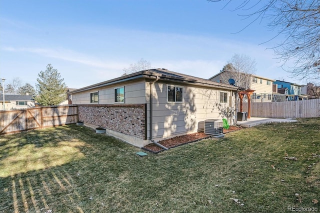 back of property featuring a yard, a patio area, and central air condition unit