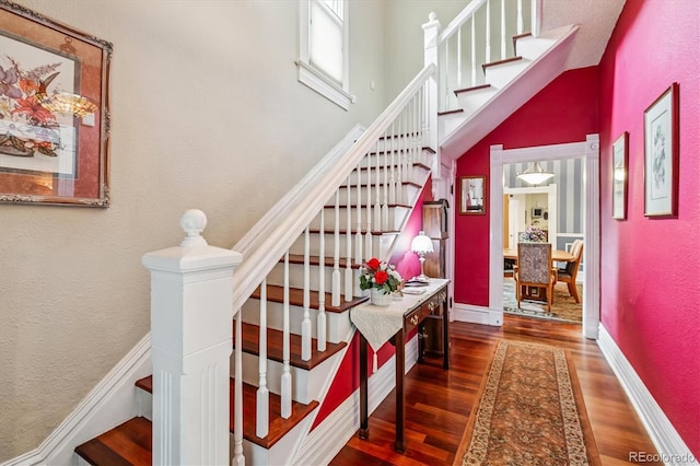 912 S Washington St, Denver, CO 80209 - stairs featuring wood finished floors, a textured wall, and a high ceiling