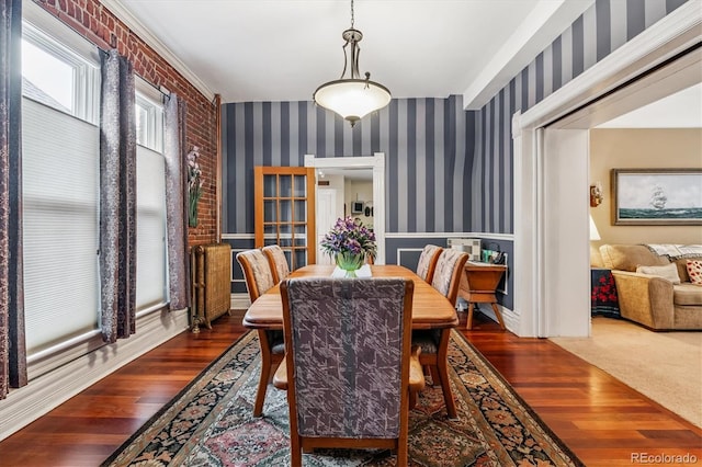 912 S Washington St, Denver, CO 80209 - dining space with wallpapered walls, wood finished floors, and wainscoting
