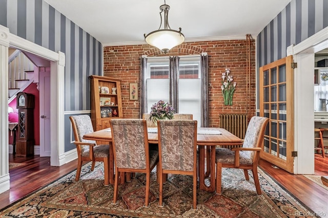 912 S Washington St, Denver, CO 80209 - dining space featuring wallpapered walls, wood finished floors, and crown molding