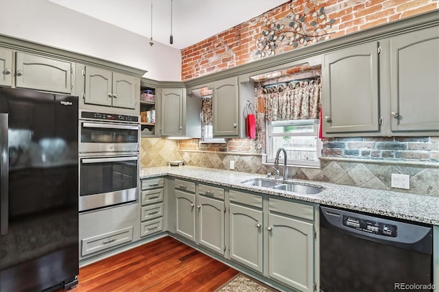 912 S Washington St, Denver, CO 80209 - kitchen with freestanding refrigerator, black dishwasher, double oven, light stone counters, and open shelves