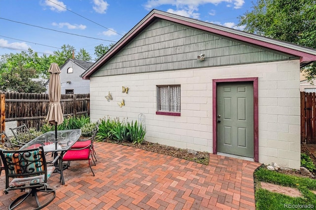 912 S Washington St, Denver, CO 80209 - rear view of house with a fenced backyard, a patio area, outdoor dining area, and concrete block siding