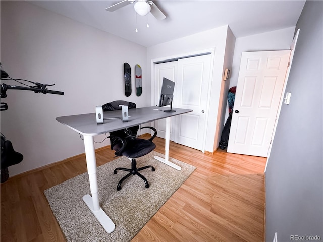 office area with light wood-style flooring and a ceiling fan